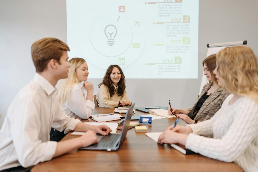 Best Digital Marketing Agency A diverse team of young professionals engaged in a collaborative meeting in an office setting.